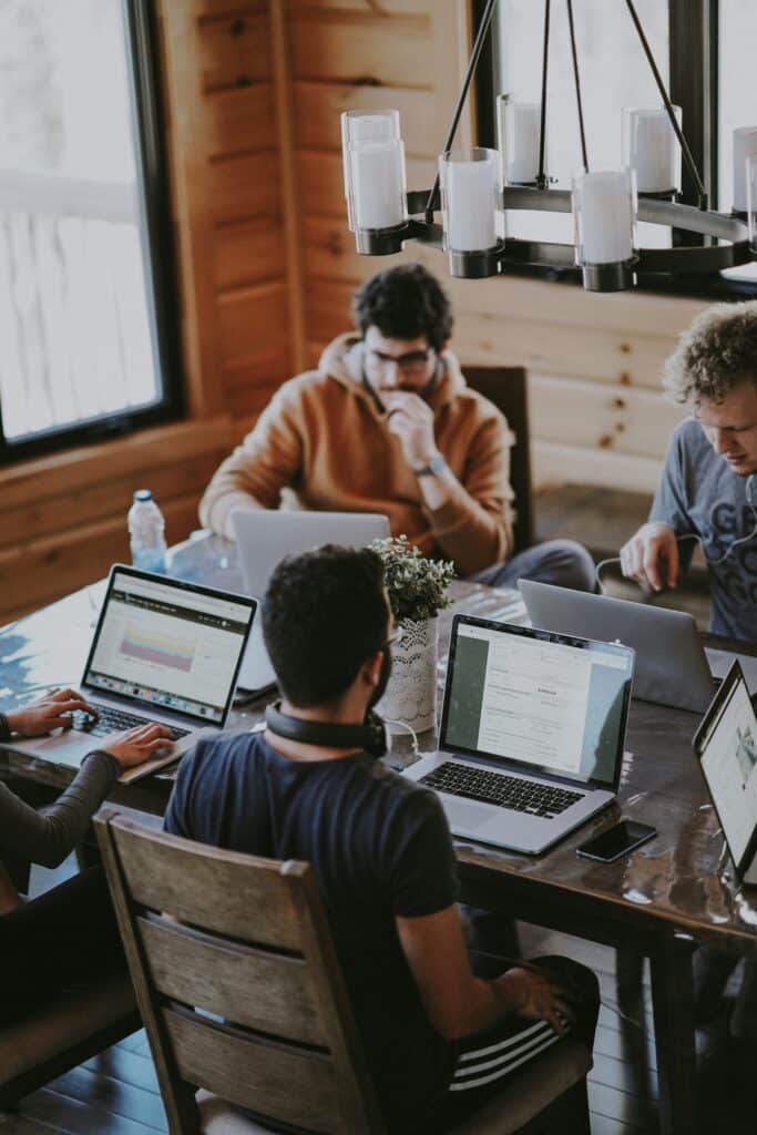 IT team working together on laptops in a modern office